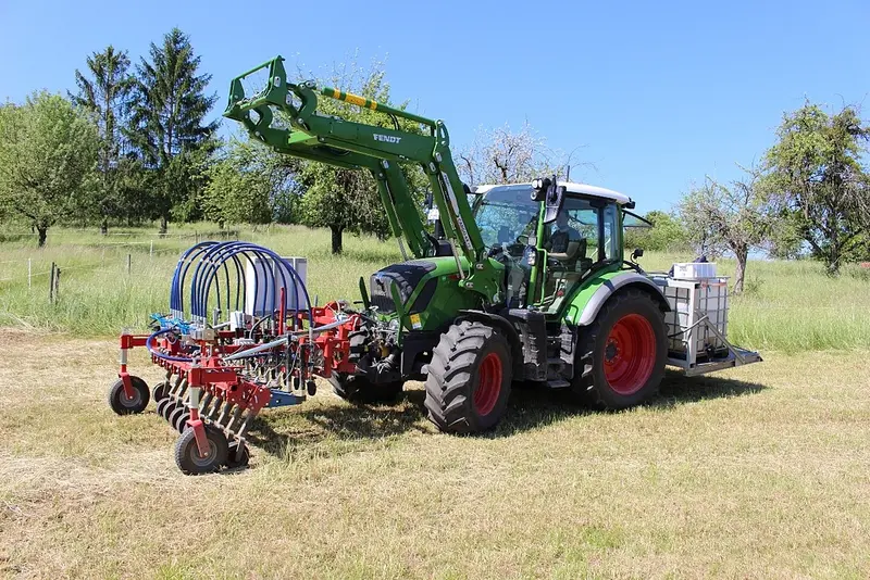 Traktor mit Spezialausrüstung auf abgemähtem Feld